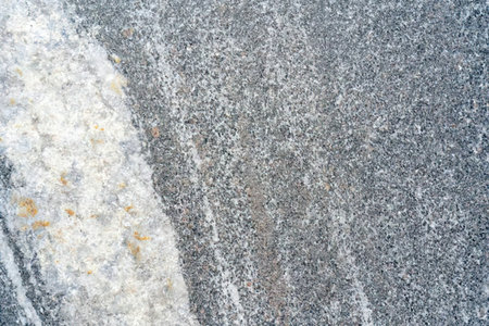 Gray granite texture with subtle white and beige streaks creates a sophisticated natural stone...