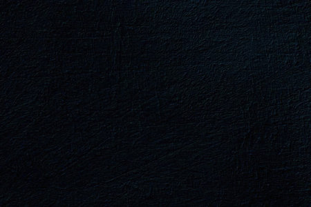 Black textured leather surface with subtle scratches and imperfections creating a luxurious and...