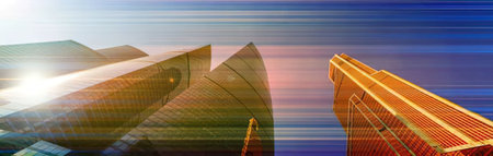 Sleek modern buildings stand tall in a bustling cityscape with vibrant colors and dynamic motion during sunrise, symbolizing urban development and corporate success in a futuristic atmosphere.の写真素材