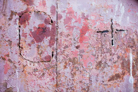 Old worn metal surface with peeling paint and rust showing significant signs of decay and damage...