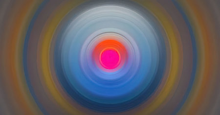 Bright pink centered concentric circles create a dynamic visual effect with a blurred multicolored...