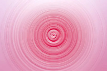 Vibrant pink spiral pattern featuring concentric circles and soft gradient effect creates a visually...