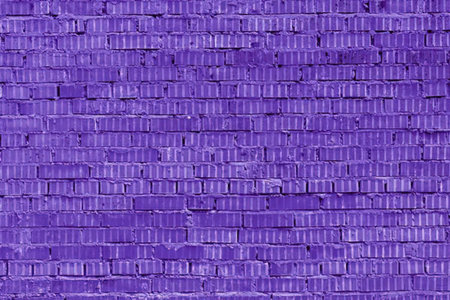 Purple brick wall with uniform bricks and textured surface creating a vibrant and artistic...