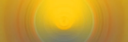 Soft and vibrant yellow and orange abstract background featuring a circular gradient and swirling patterns that creates a warm and calming atmosphere.の写真素材