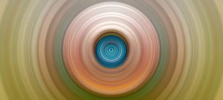Vibrant concentric circles create a spiral motion effect in a blurred abstract background with...