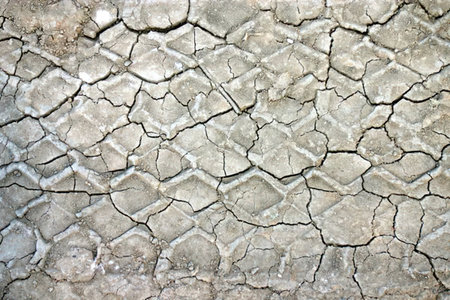 Dry cracked earth surface symbolizing severe drought and environmental degradation, showing cracked...