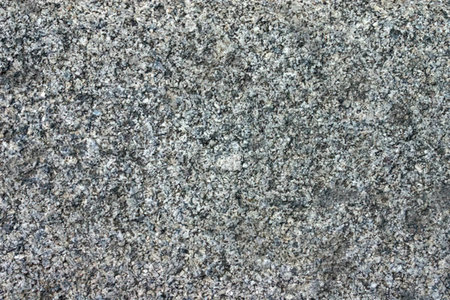 Speckled granite stone texture featuring a mix of gray tones and rough surface adding natural beauty...