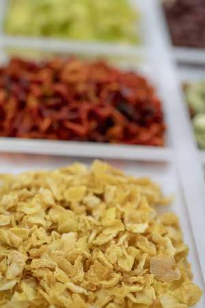 Dried ingredients arranged on white serving plates for various recipe preparations and cooking...
