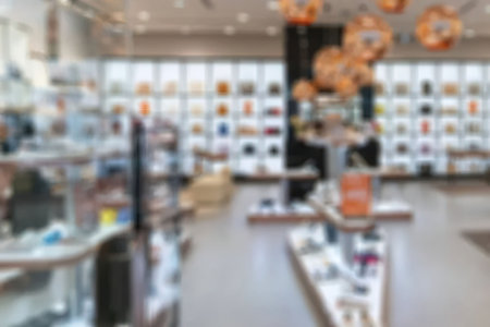 Modern retail store interior features blurred background with various display fixtures showcasing...