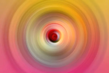 Bright colorful abstract background featuring concentric circles with a glowing red center, creating...