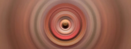 Concentric circles in shades of red and orange create a vibrant abstract design, producing a hypnotic visual effect that draws the viewer's attention to the center.の写真素材