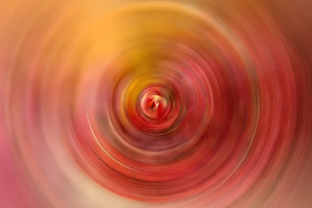 Vibrant red and orange spiral pattern creates a dynamic abstract background suitable for creative...