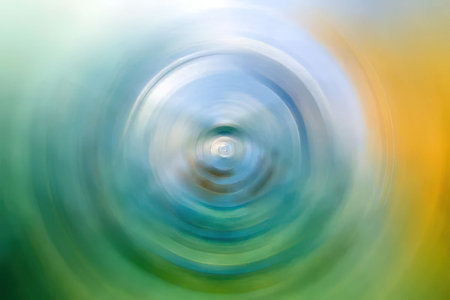 Vibrant abstract background featuring swirling patterns of blue, green, and yellow colors creates a...