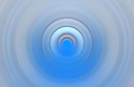 Concentric blue circles forming a tunnel effect create a sense of depth and movement in this digitally generated abstract image.の写真素材