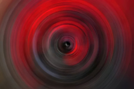 Red and black swirling vortex creates a dynamic abstract background with a sense of motion and...