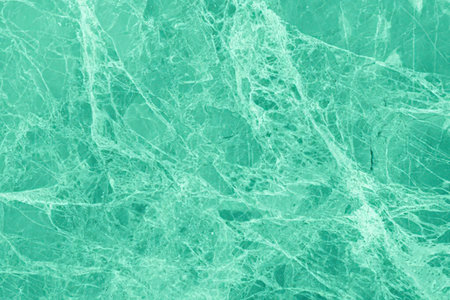 Beautiful green marble surface with intricate natural veining patterns, showcasing a luxurious and...