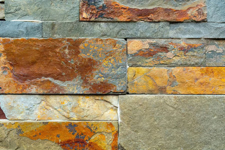 Various large stone bricks in different colors and textures are arranged in a rustic pattern.