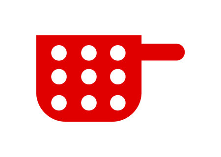 Red cooking pot with white circles isolated on white backgroundの写真素材