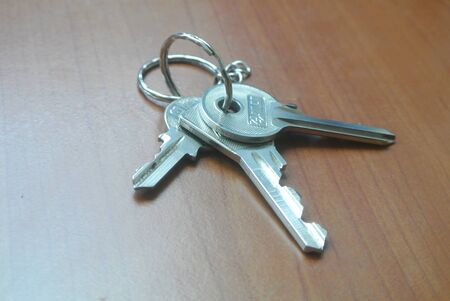 Bunch of keys on wooden tableの写真素材