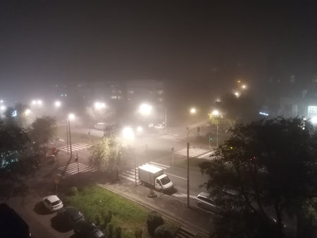 Aerial view of foggy city street at night. Heavy fog in the city.の写真素材