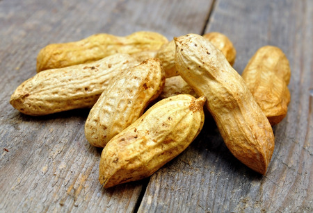 peanuts in the shell on a wooden table