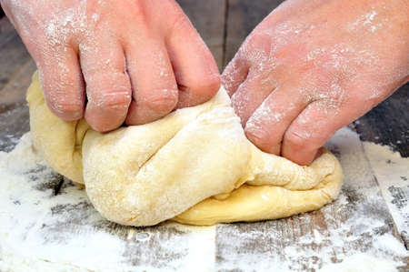 female hand kneads dough