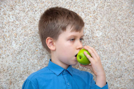 Child boy with apple, healthy food.の写真素材