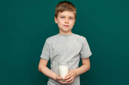 Boy child holding a glass of milk in her handsの写真素材