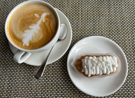 Cappuccino coffee and eclair cake with cream