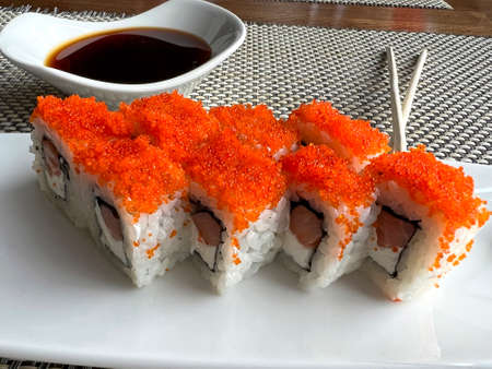 Rolls with salmon and cheese in a plate and soy sauceの写真素材