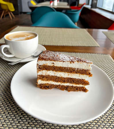 Cappuccino coffee and cake with cream