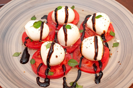 Tomato and mozzarella Caprese salad with sauceの写真素材