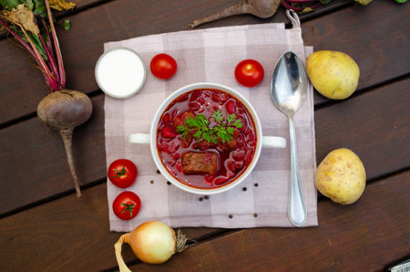 Borscht soup with vegetables and meat on a wooden tableの写真素材