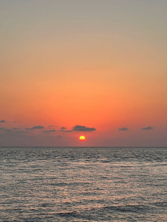 Red sun setting over the sea