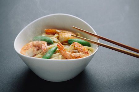 hot noodles with shrimps on a black backgroundの写真素材