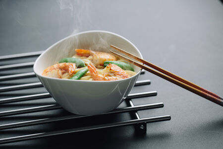 hot noodles with shrimps on a black backgroundの写真素材