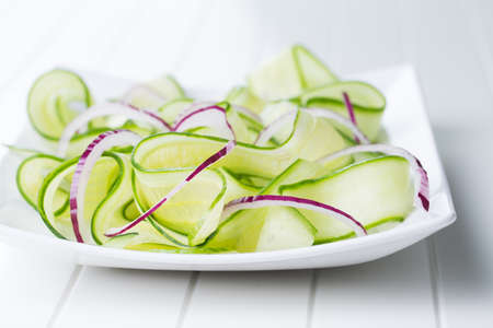 fresh healthy salad of cucumber on a tableの写真素材