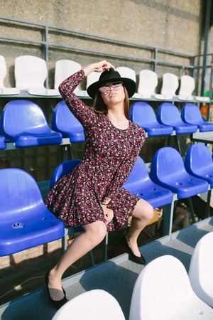 Girl in dress posing in the stadiumの写真素材