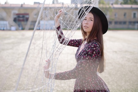 Girl in dress posing in the stadiumの写真素材