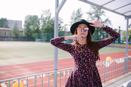 Girl in dress posing in the stadiumの写真素材