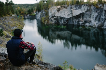 man photographing a beautiful view from the cliff