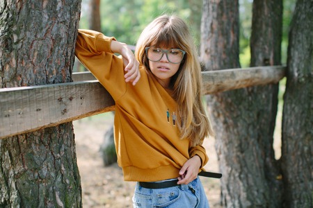 Beautiful hipster girl in shorts posing at the parkの写真素材