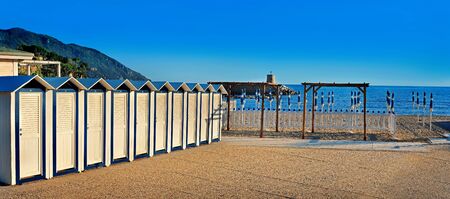 Beach cabanas on the seafront with blue skyの写真素材