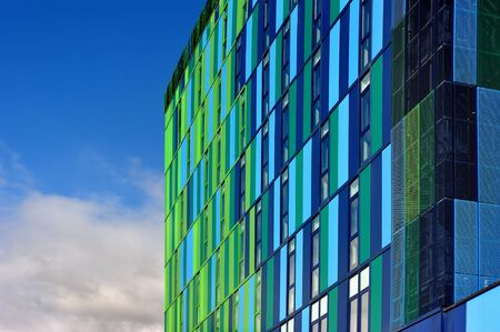 Glass facade with cloudy blue skyの写真素材