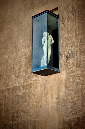 sculpture of a woman behind the glass installationの写真素材