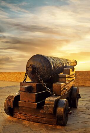 old pirate gun on nuclei at sunsetの写真素材