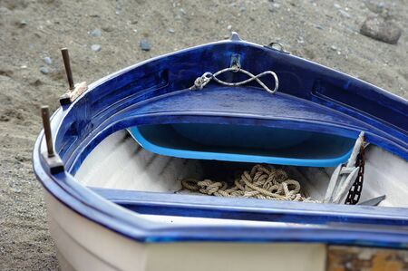 White-blue boat on a sandy beach with ropeの写真素材