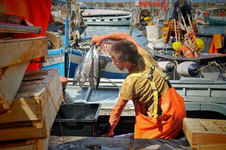 Camogli, Liguria, Italy - June 15, 2015 Fishermans with a catch in Camogli portのeditorial素材