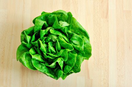 fresh green lettuce from above on wooden tableの写真素材