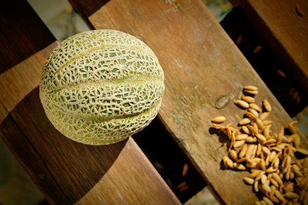 fresh melon on wooden background with seedsの写真素材